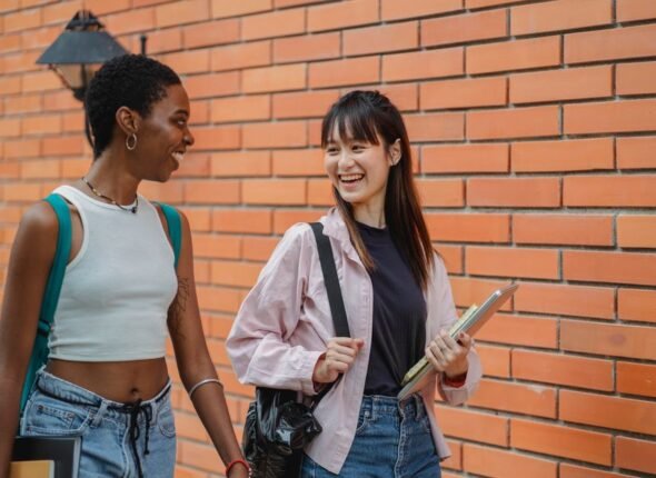 Two students walking together on a university campus