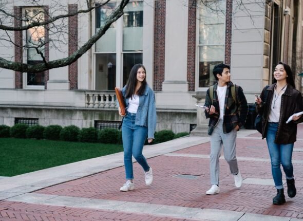 Group of international students walking together on a UK university campus